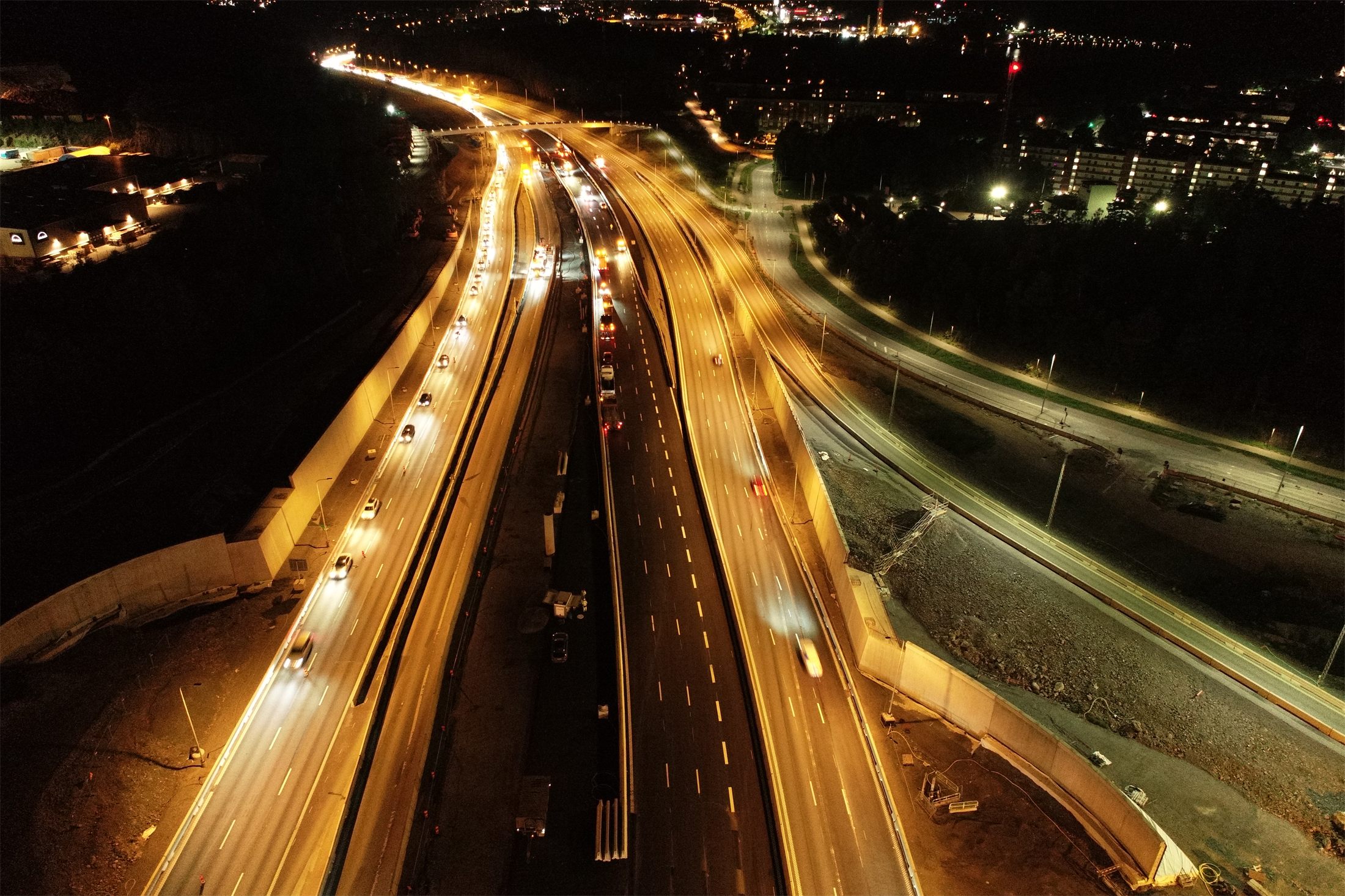 Road widening works beside live traffic at night